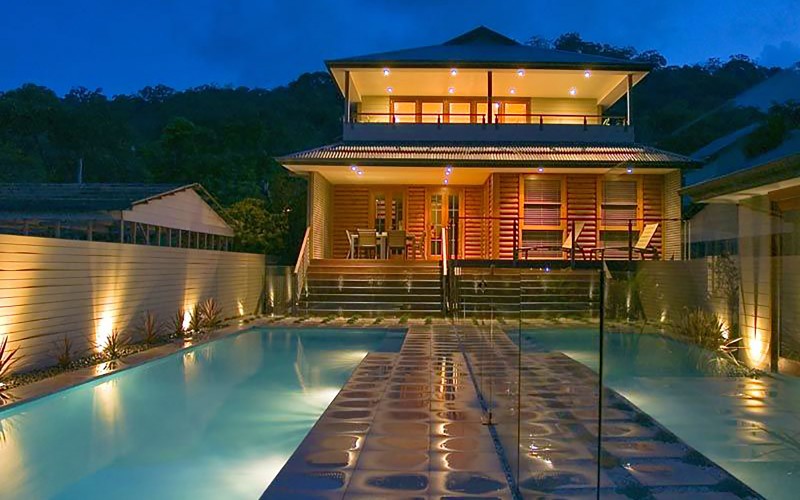 Central Coast builders showcase new home with the pool lit up at night